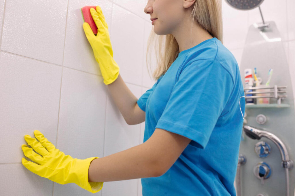 woman cleaning a shower